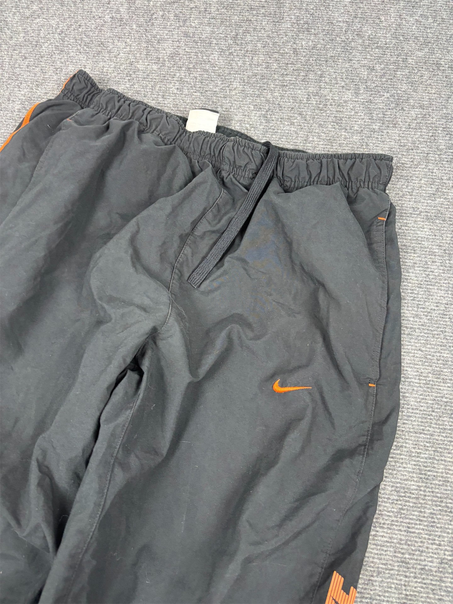 Men's Classic Nike Track Pants Size M Black Orange Piping Swoosh Spell Out Logo Cuffed Ankles Wide Leg