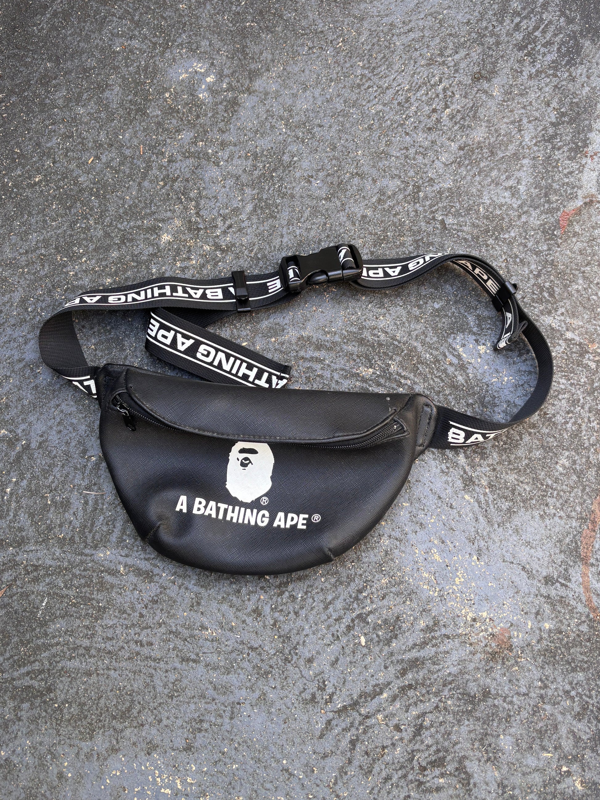 Black and gray bag with 'A Bathing Ape' branding on a textured surface