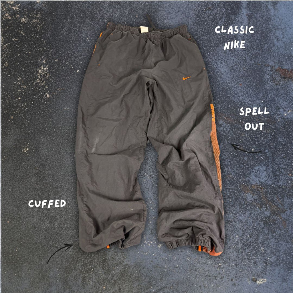 Men's Classic Nike Track Pants Size M Black Orange Piping Swoosh Spell Out Logo Cuffed Ankles Wide Leg